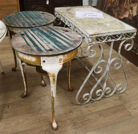 A pair of early 20th century cast iron garden tables, with later wooden tops, and a wrought iron marble top garden table diameter 59cm